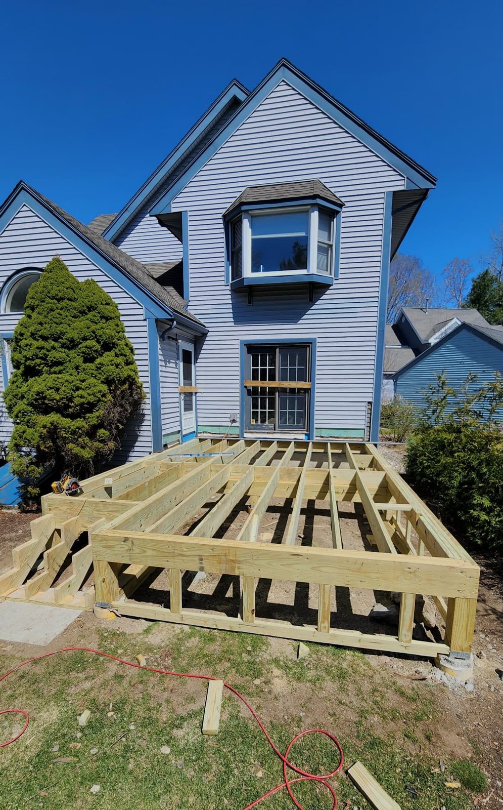 Pressure-treated deck framing built at the rear of a home