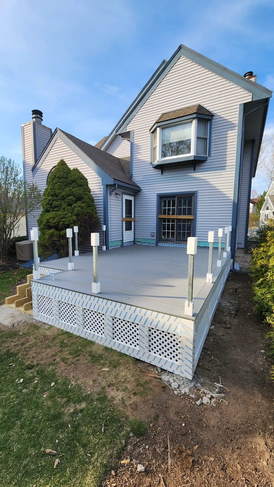 Finished composite deck with railing posts and lattice skirting