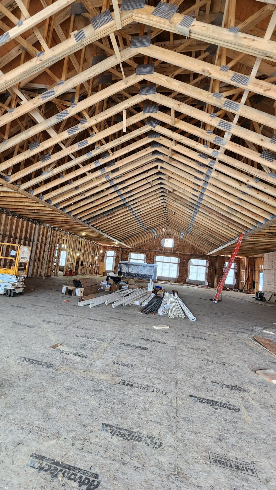 Structural subfloor and roof trusses on a large open-span build